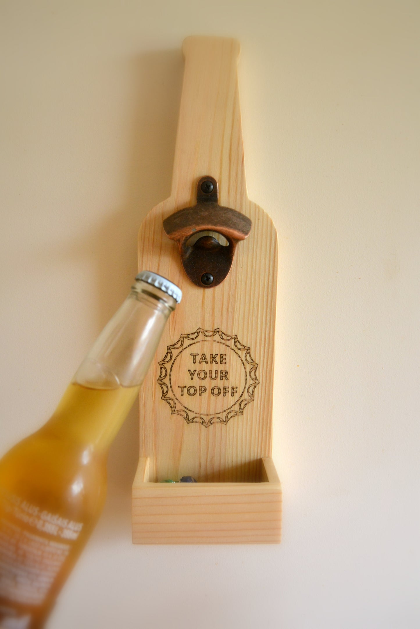 Hanging beer opener with cork catcher